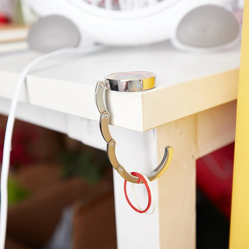 PORTABLE FOLDING BAG HANGER FOR TABLES